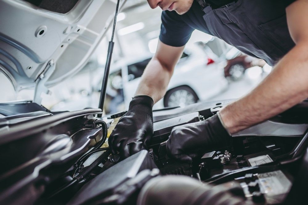 An image of a car being serviced by a licenced mechanic.